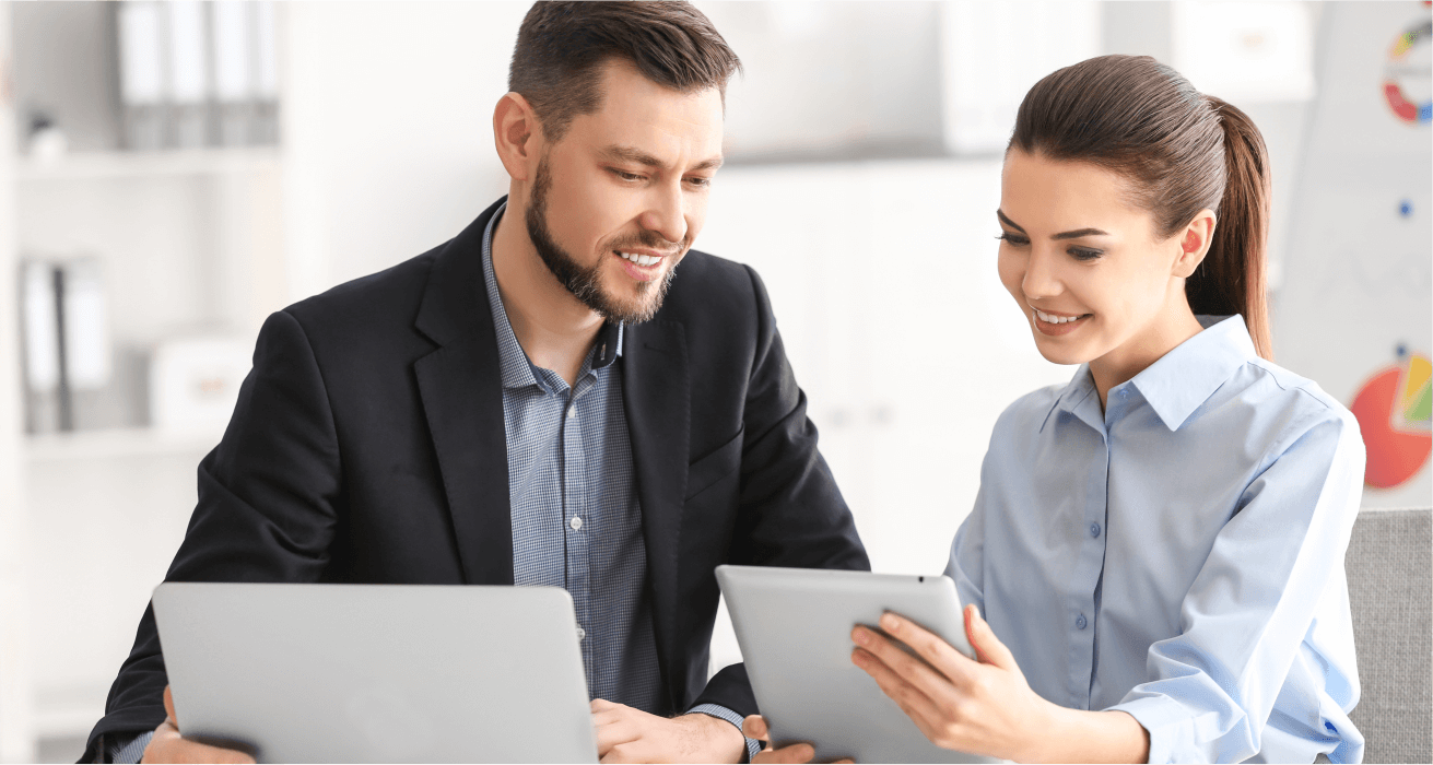 Two colleagues discussing a project using a tablet