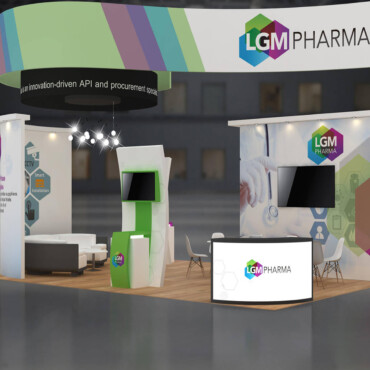 LGM Pharma booth with a multicolored overhead sign, display towers and a reception counter.