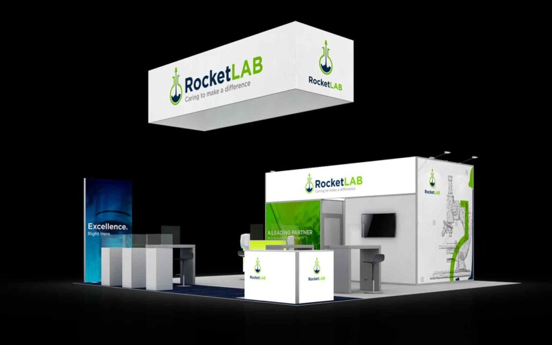 RocketLAB booth with a suspended rectangular sign, white-and-green display walls and demonstration counters.