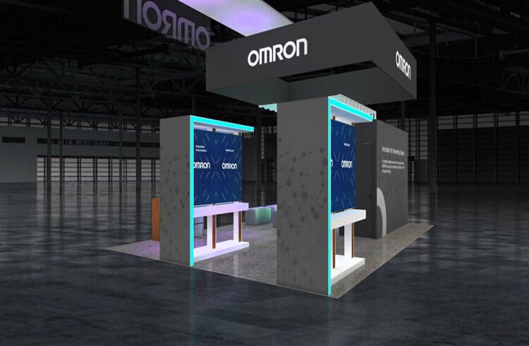 Omron booth design with a suspended sign and illuminated demonstration panels