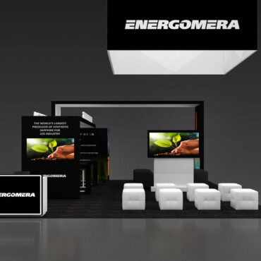 Energomera booth with a suspended black sign, product screens and rows of white seats.